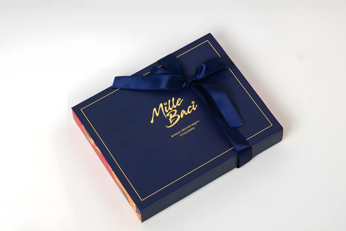 Signature, a navy box with a satin ribbon