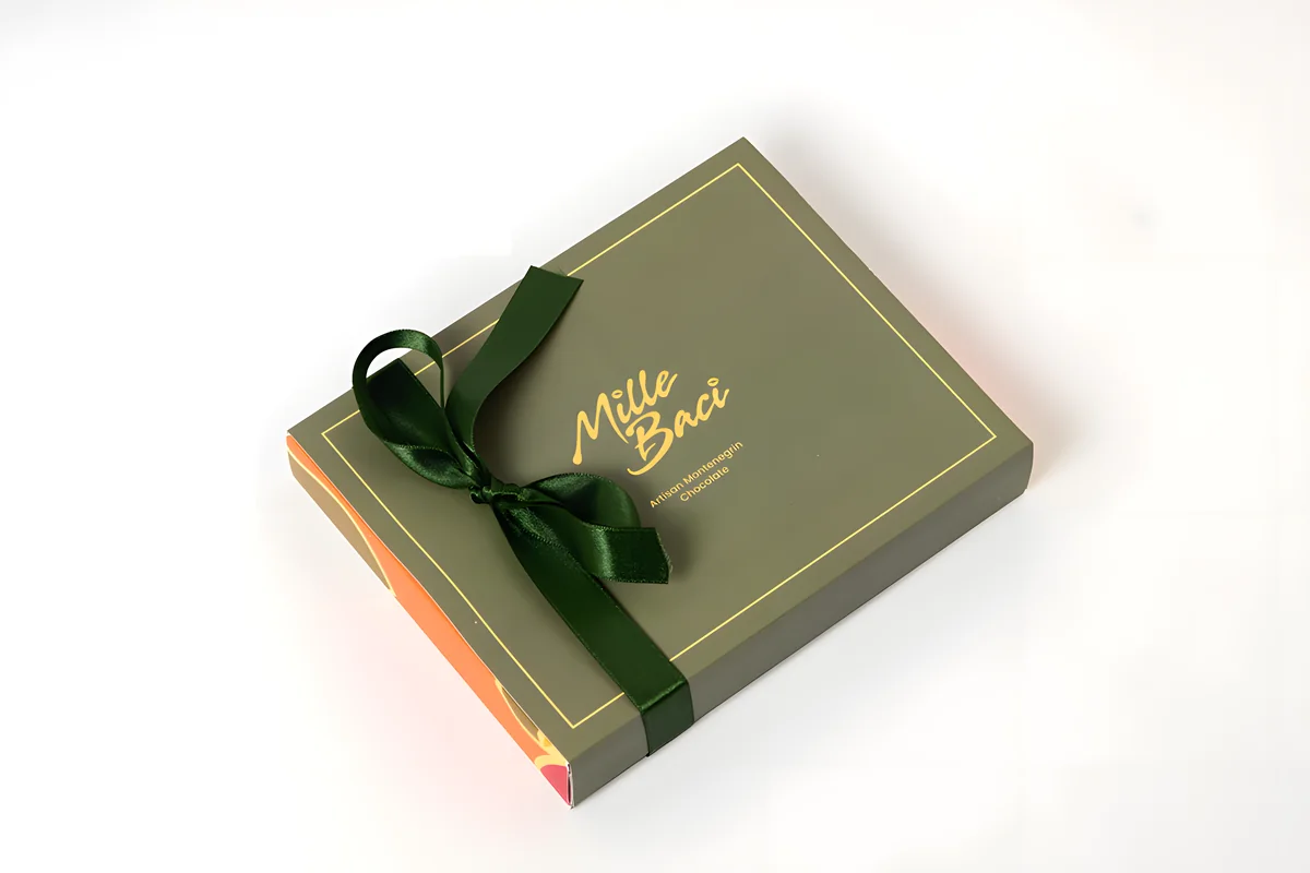 Signature, a olive green box with a satin ribbon