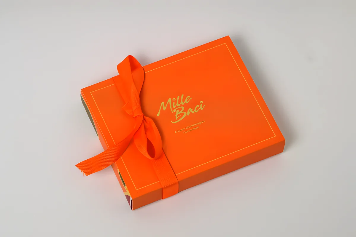 Signature, a orange box with a satin ribbon