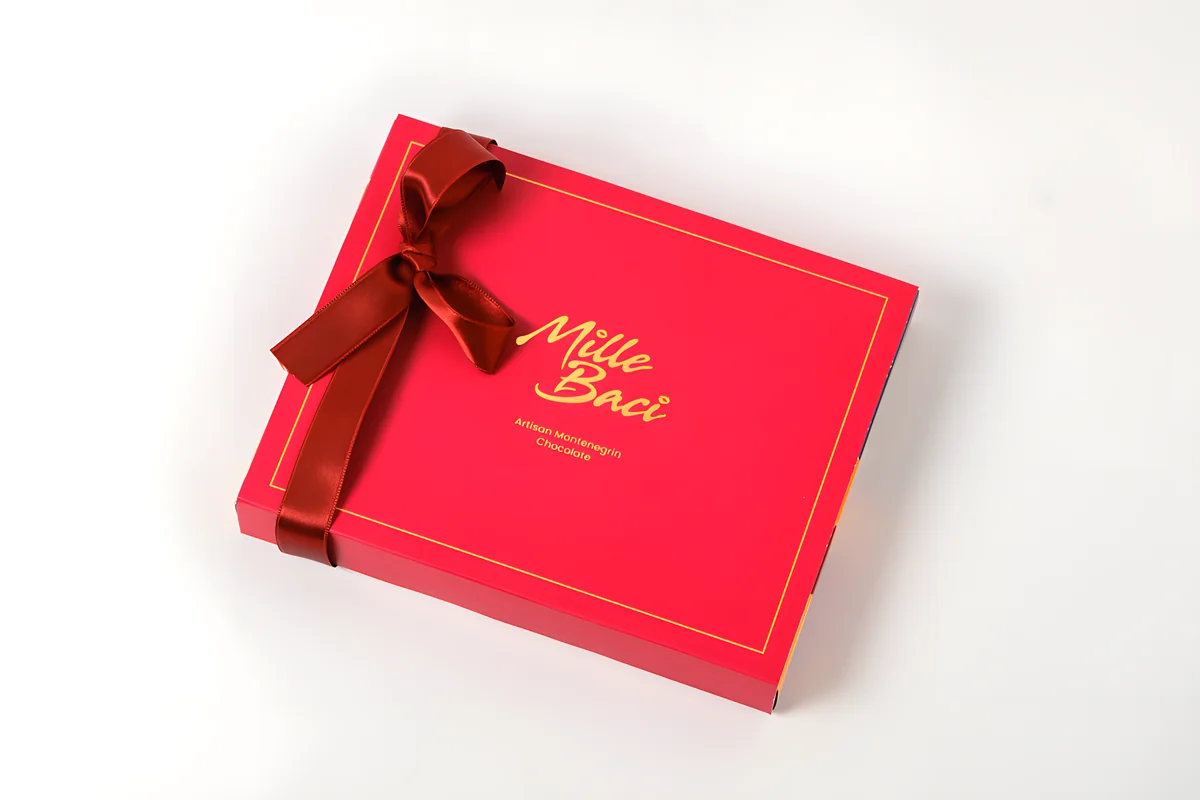 Signature, a red box with a satin ribbon